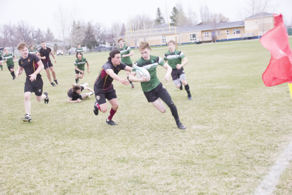 Alex Thompson tries to cut the corner on a Crocus Plains defender.