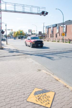 Sidewalk decals highlight rail crossing risks